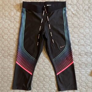 Nike Black Dri-Fit Capri Leggings with Retro Pink, Purple, and Blue Stripes